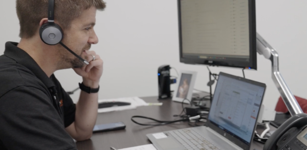 Chris Lintner, Commercial Director at EvenMix, working with customers at his desk using sales and production systems.